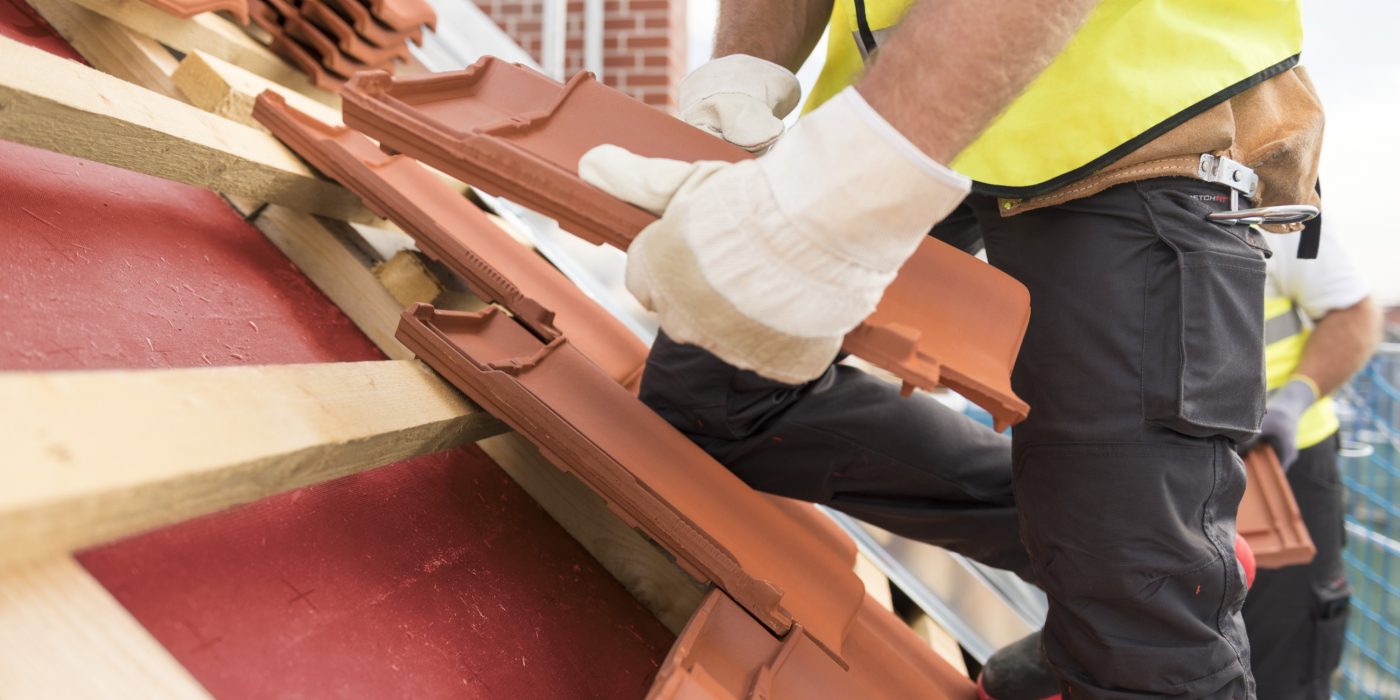 Urban roofers roof installation with Alegra roof tiles wearing safety gloves and safety jackets