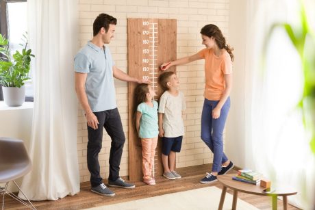 Parents measuring children's height