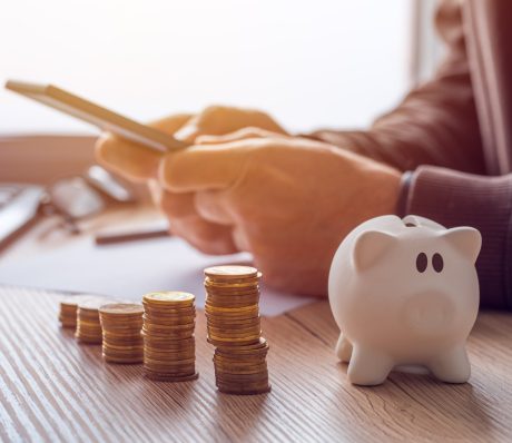 Savings, finances, economy and home budget calculations. Close up of man doing calculations and writing notes at home.