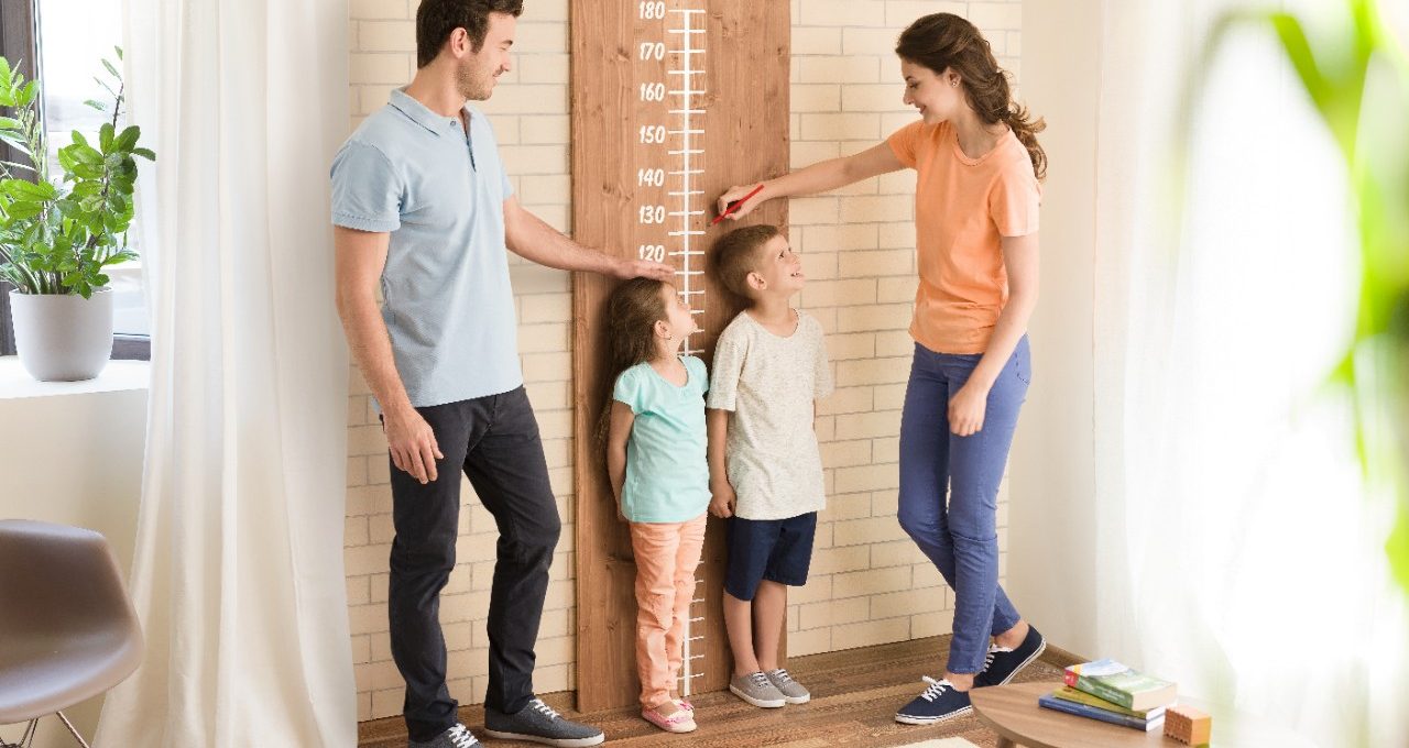 Parents measuring children's height