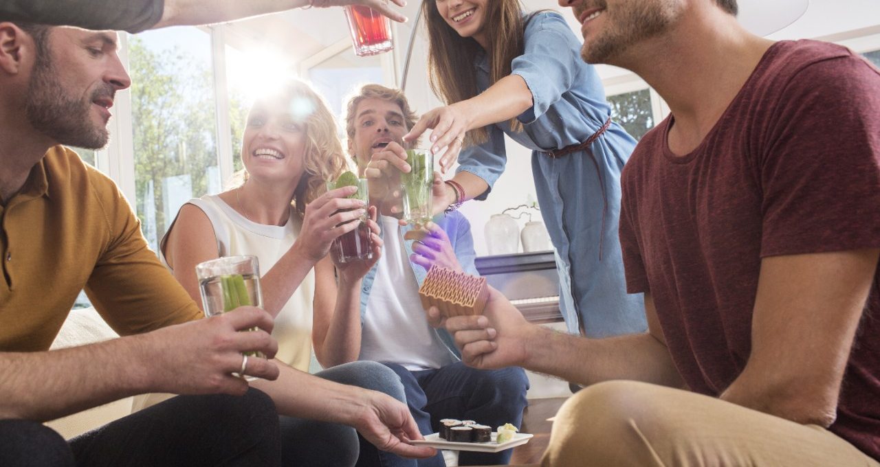 Indoor party situation with adults drinking cocktails