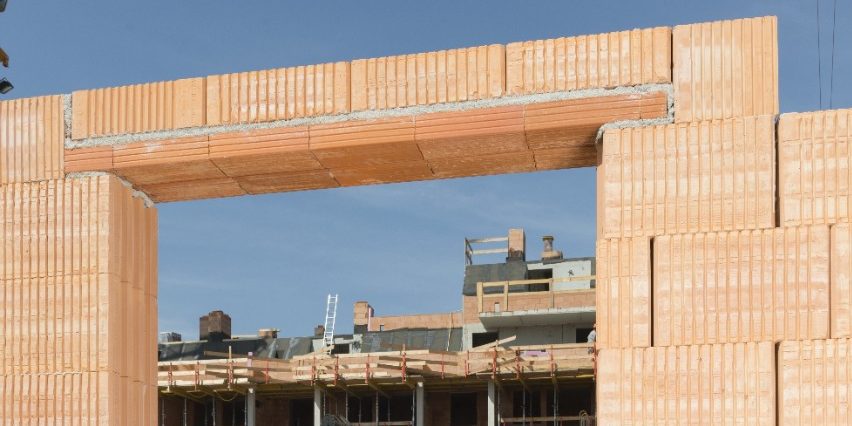 Female architect checking door frame on construction site