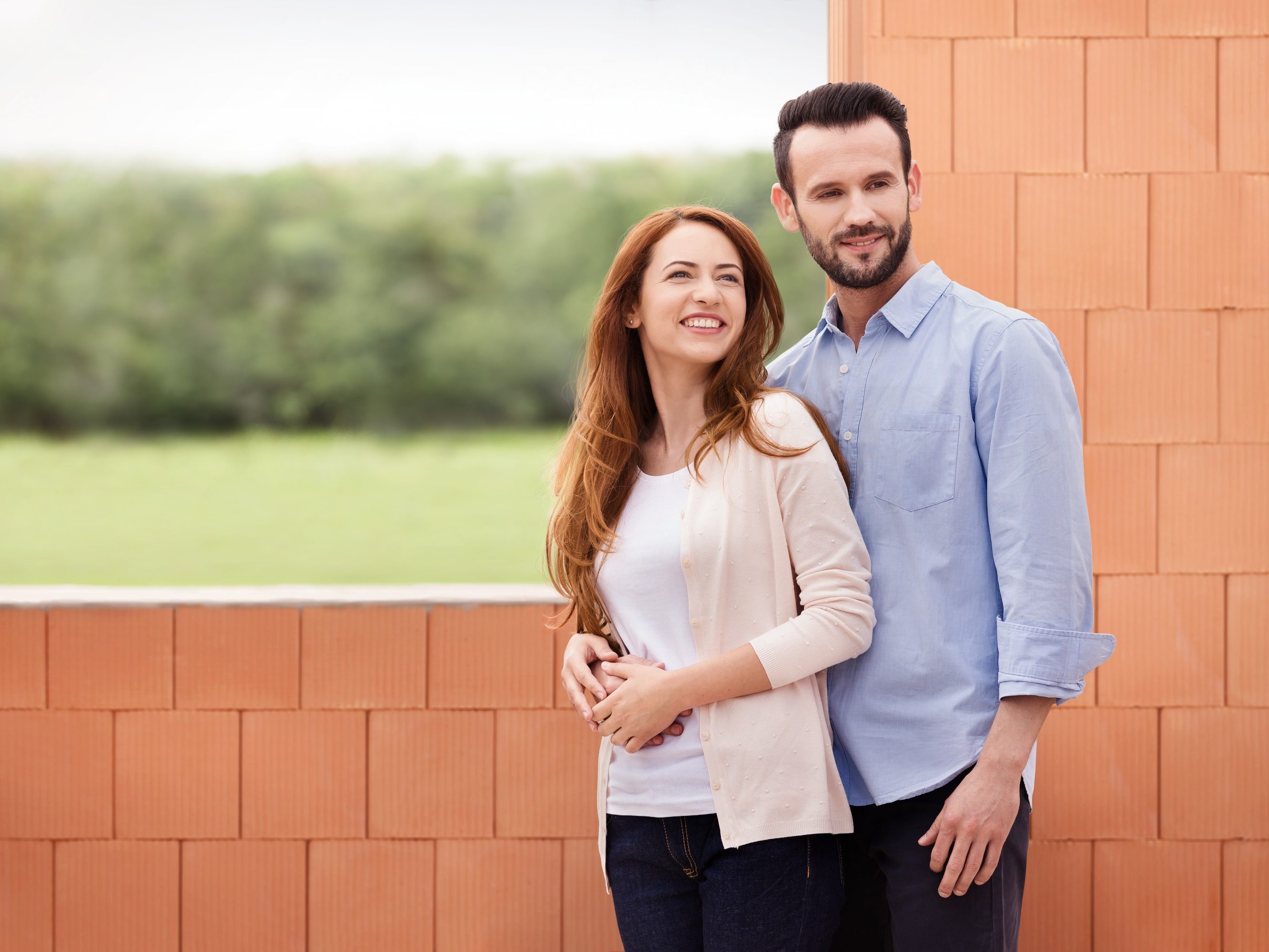 Couple inside their future home inside building shell